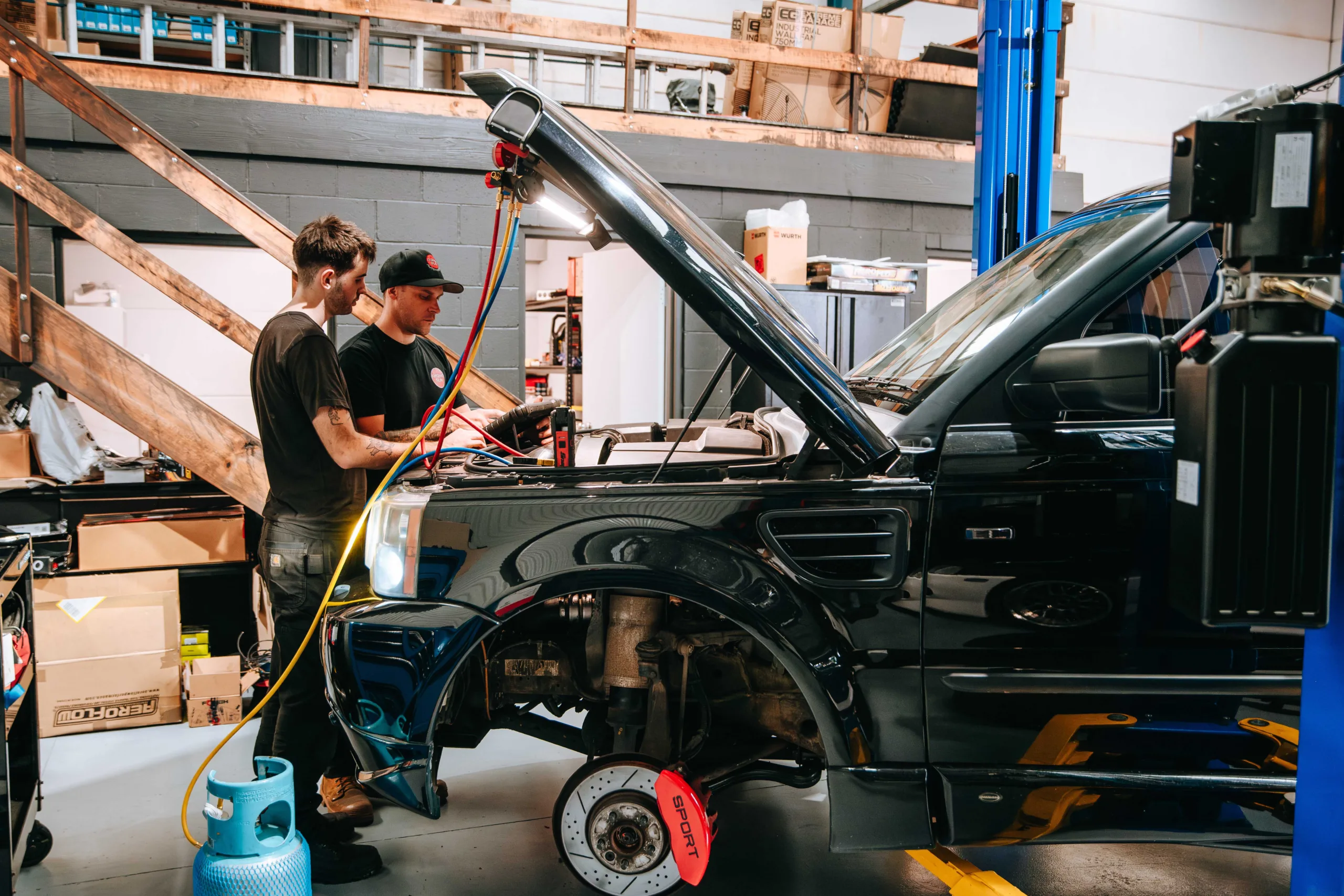 Light vehicle car mechanic apprentice getting hands on learning from Host Employer